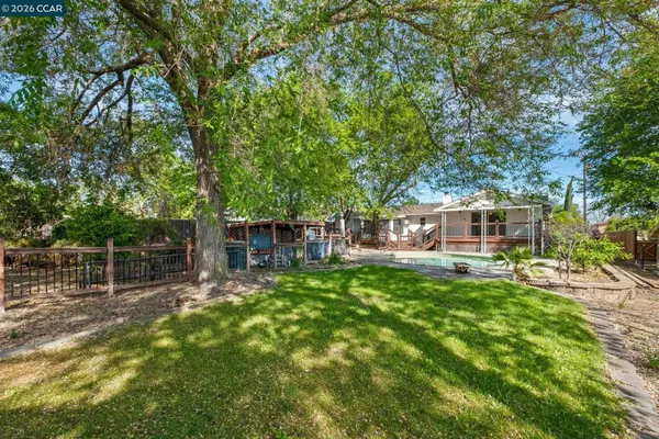 a backyard of a house with table and chairs
