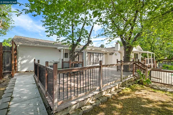 a view of a house with wooden deck