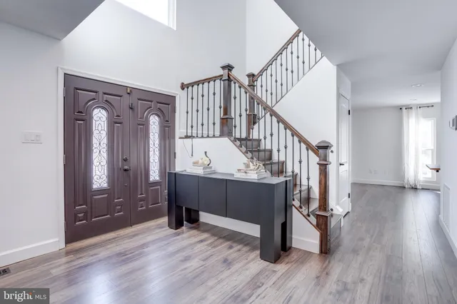 a view of entryway and hall with wooden floor