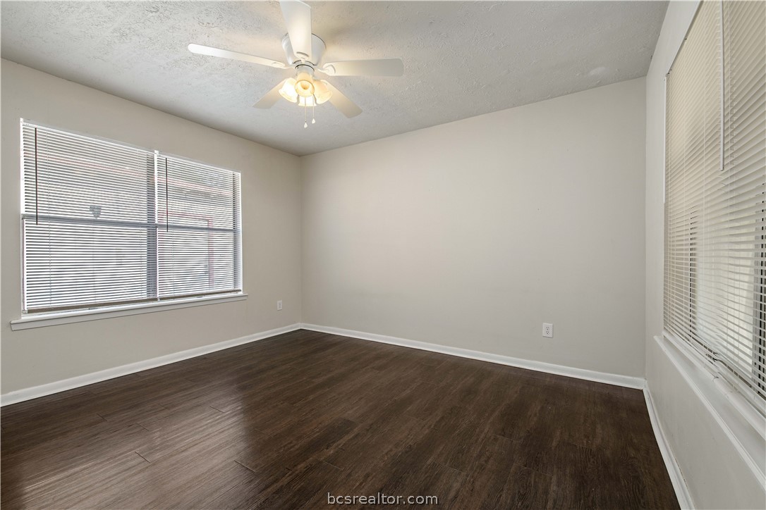 4403 Robinhood Circle Bryan, TX 77803 - Photo 12 of 19 an empty room with windows and chandelier fan