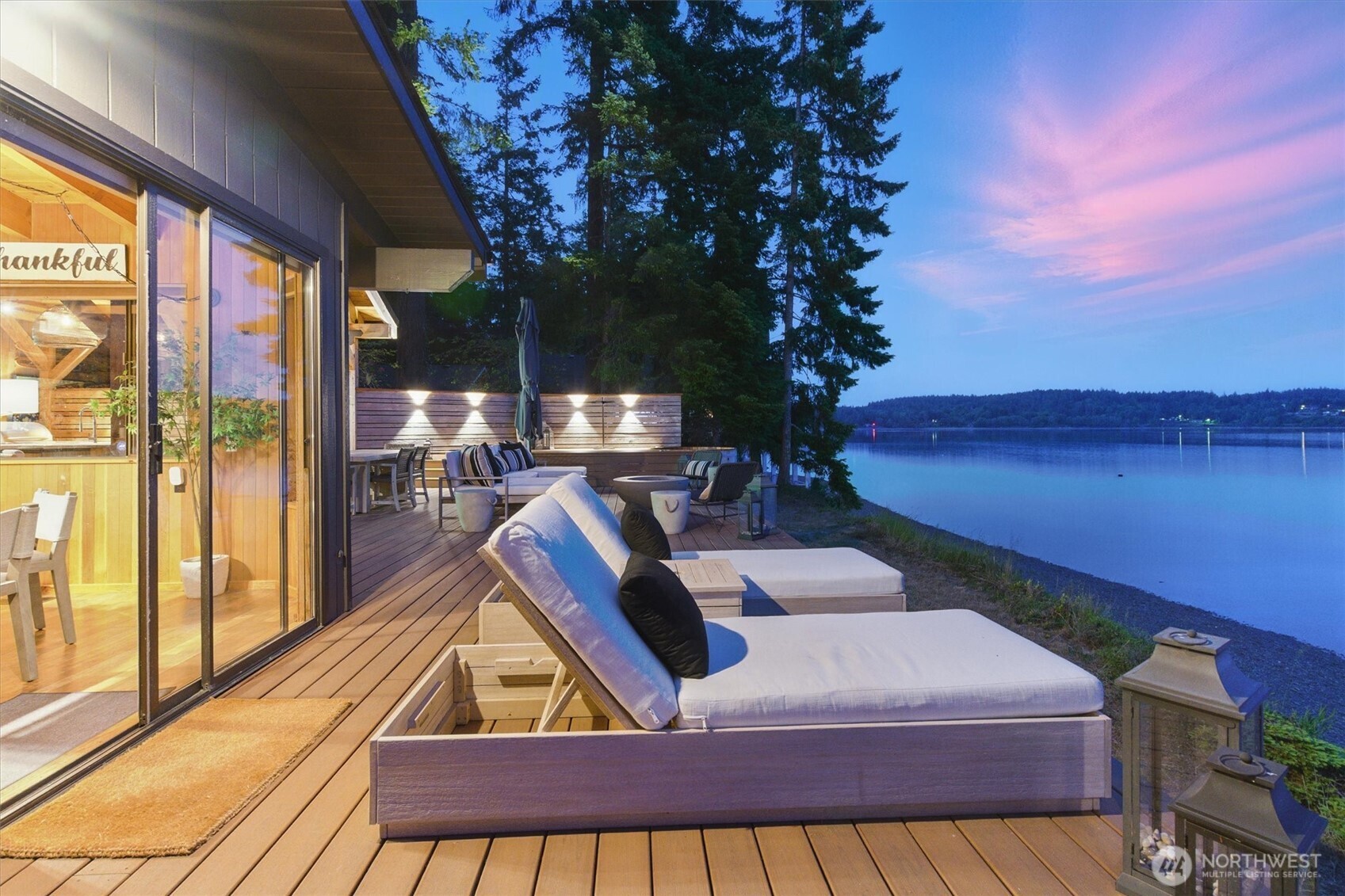 6570 East Grapeview Loop Road Allyn, WA 98524 - Photo 18 of 38 a view of swimming pool with seating area and trees in the background