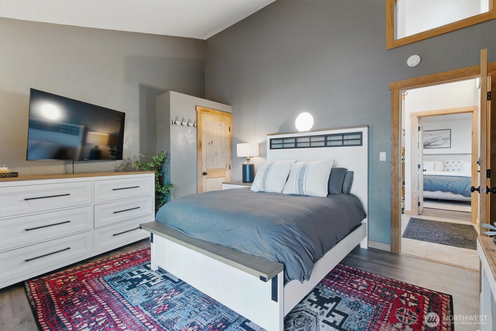 6570 East Grapeview Loop Road Allyn, WA 98524 - Photo 21 of 38 a bedroom with a bed and a flat screen tv