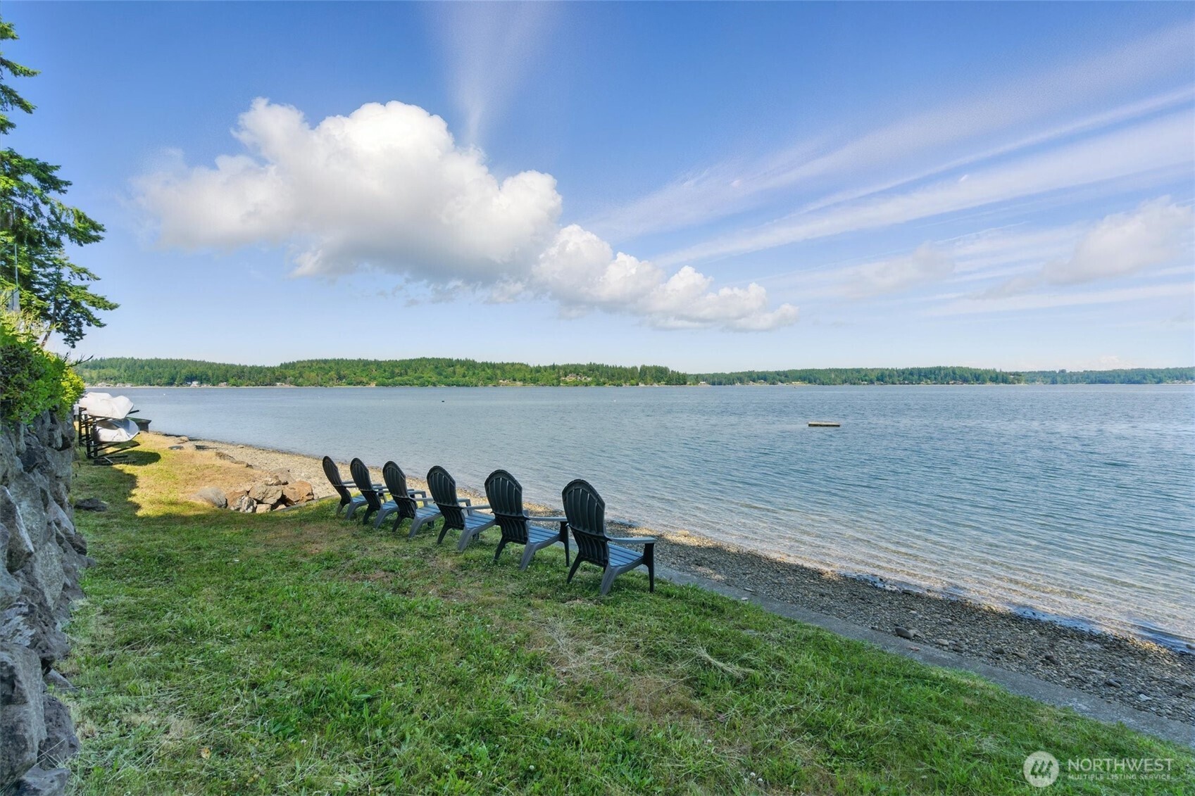 6570 East Grapeview Loop Road Allyn, WA 98524 - Photo 29 of 38 a view of a lake with houses in the back