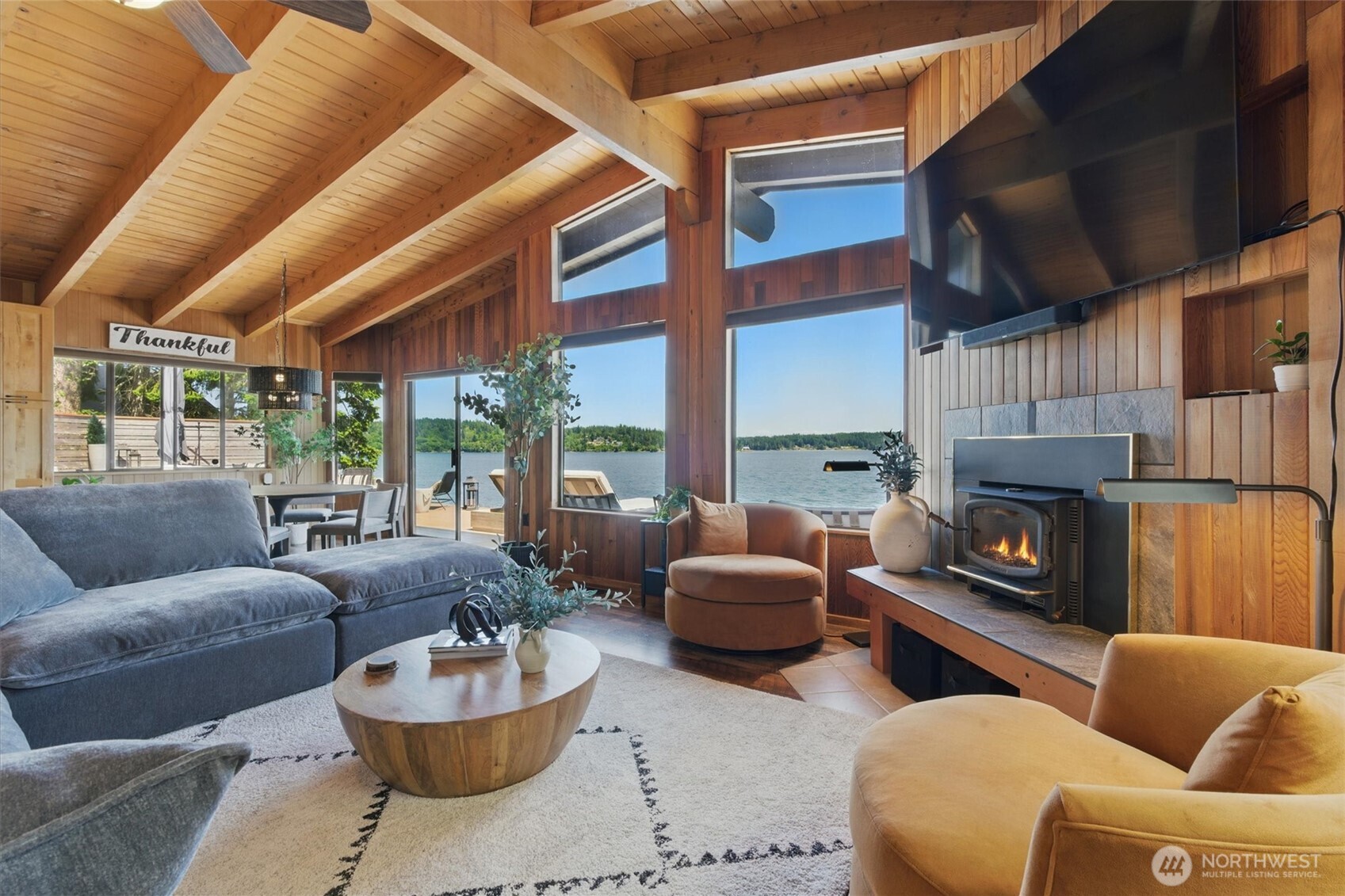 6570 East Grapeview Loop Road Allyn, WA 98524 - Photo 4 of 38 a living room with furniture a fireplace and a large window