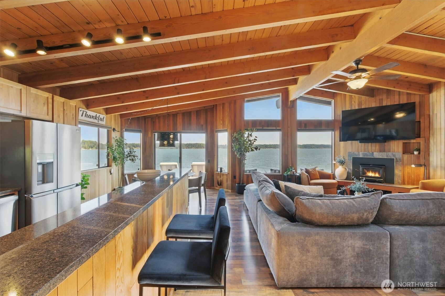 6570 East Grapeview Loop Road Allyn, WA 98524 - Photo 6 of 38 a living room with furniture and a floor to ceiling window