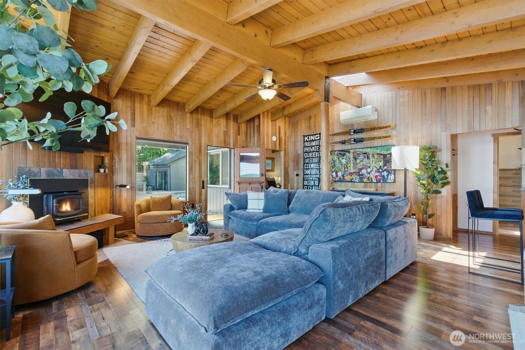 6570 East Grapeview Loop Road Allyn, WA 98524 - Photo 8 of 38 a living room with furniture a fireplace and a chandelier