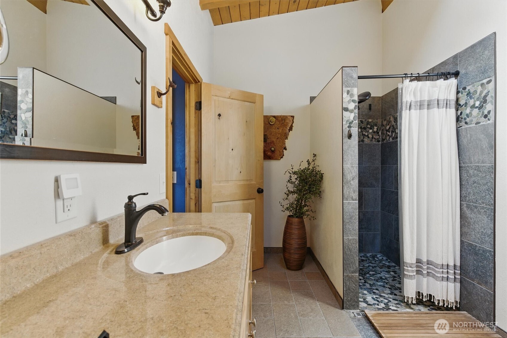 6570 East Grapeview Loop Road Allyn, WA 98524 - Photo 10 of 38 a bathroom with a granite countertop sink and a mirror