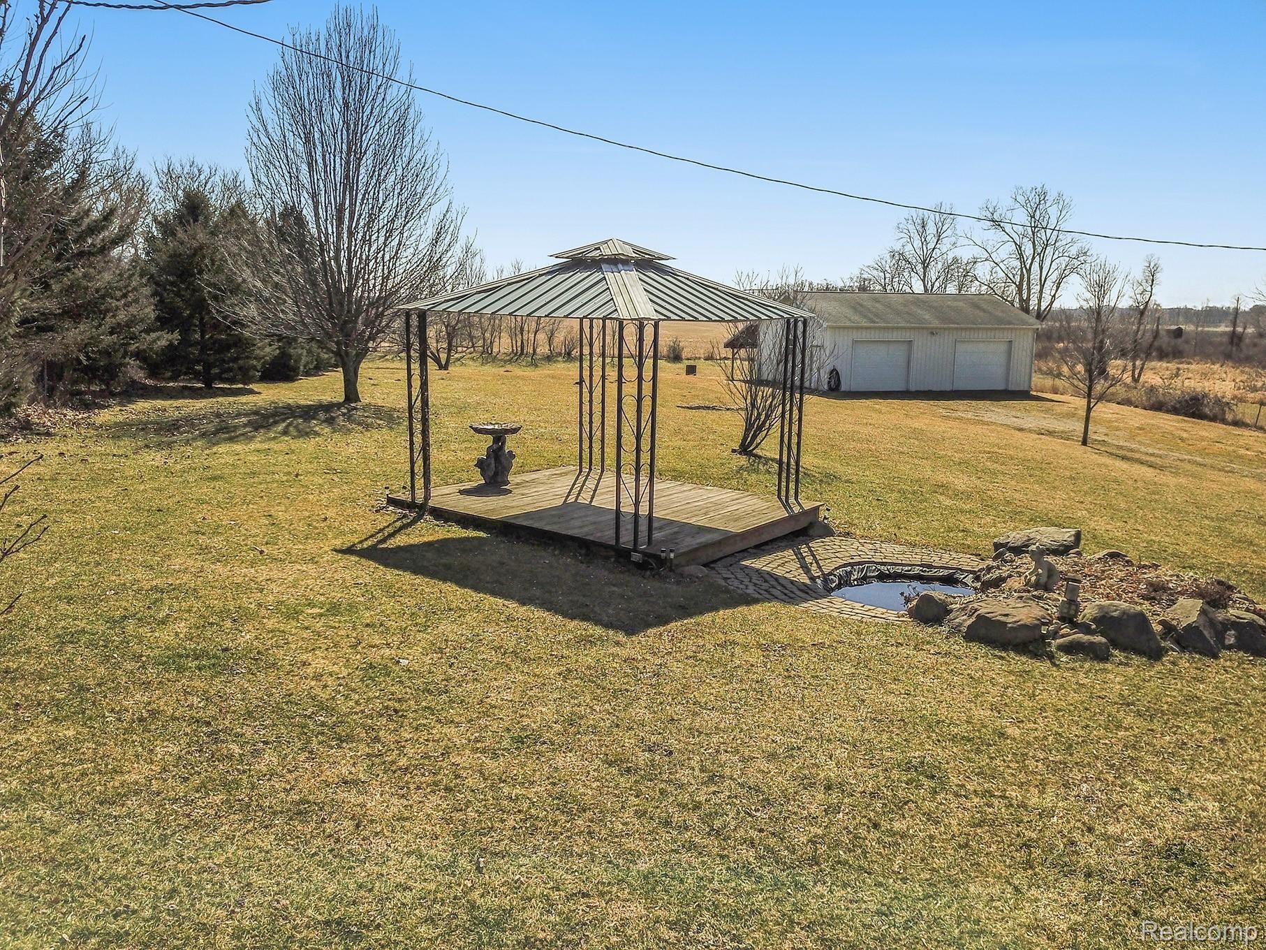 10675 Bell Oak Road Fowlerville, MI 48836 - Photo 34 of 39 Backyard Cabana and Fountain