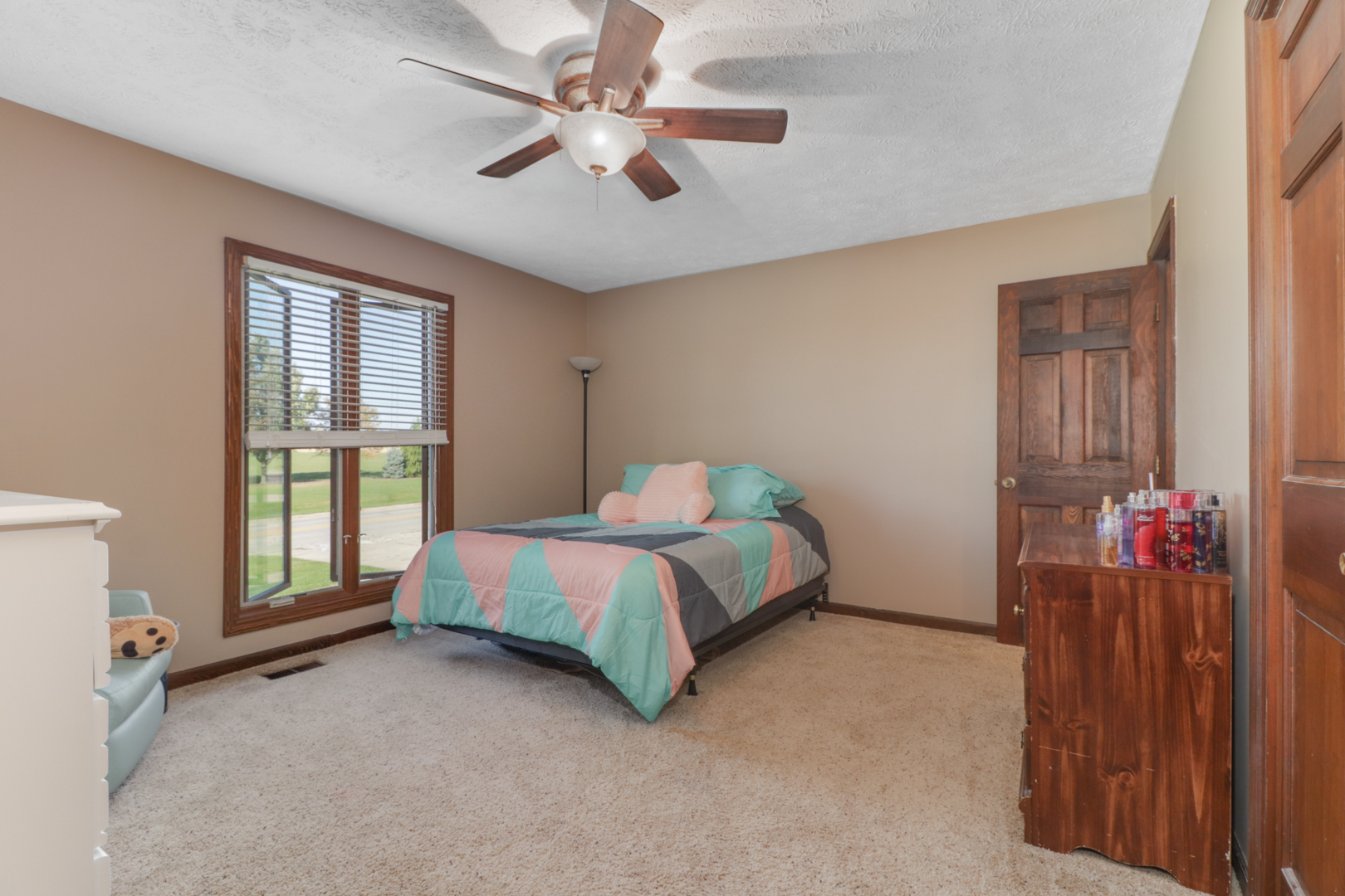 1607 Gregory Street Normal, IL 61761 - Photo 14 of 32 a spacious bedroom with a bed and a chandelier