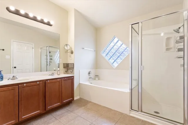 a bathroom with a bathtub a sink and a shower