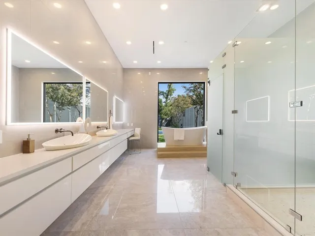 a large spacious bathroom with a large tub and shower