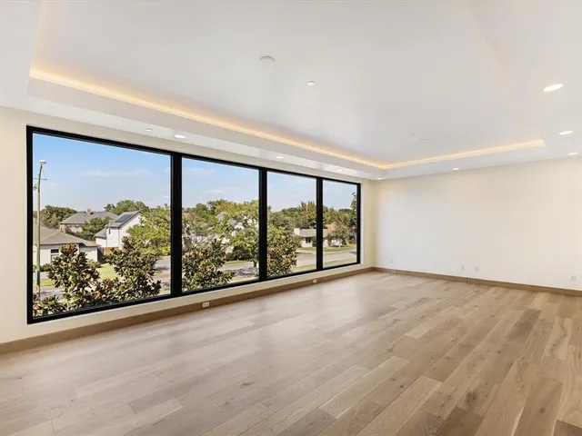 wooden floor in an empty room with a large window