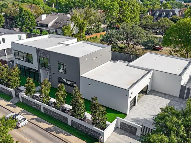 an aerial view of a house with a yard and plants