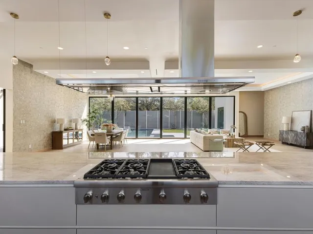 a kitchen with a stove a refrigerator and a sink