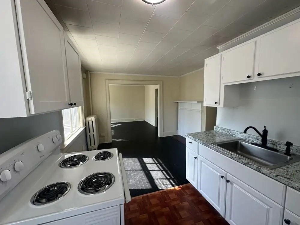 3 Marston Way Worcester, MA 01609 - Photo 17 of 25 a kitchen with a sink stove and white cabinets