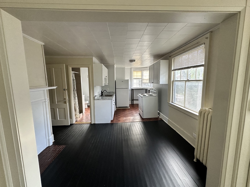 3 Marston Way Worcester, MA 01609 - Photo 20 of 25 a view of a hallway with wooden floor and a kitchen