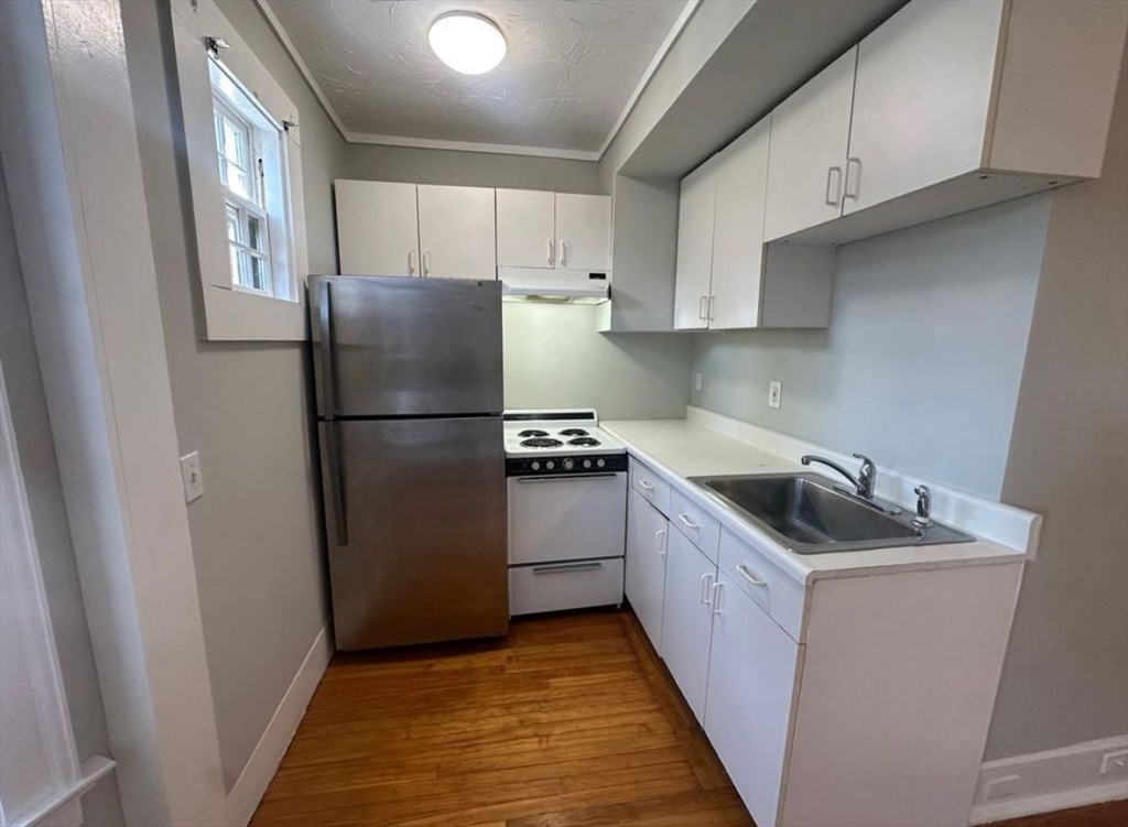 3 Marston Way Worcester, MA 01609 - Photo 23 of 25 a kitchen with a refrigerator sink and cabinets