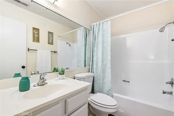 a view of balcony with small yard and wooden fence