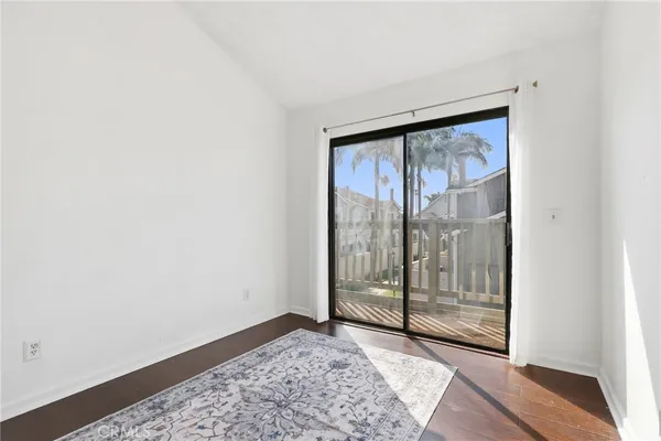 a view of a house with a yard and potted plants