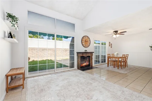 a living room with furniture a clock and a window