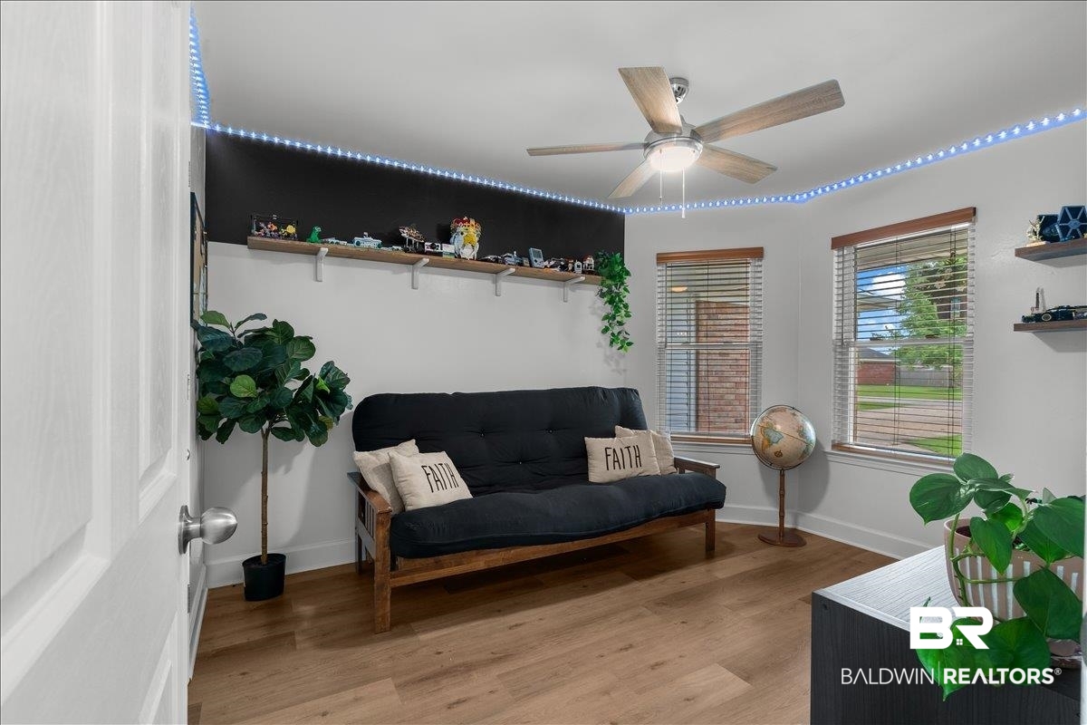 8952 Sherman Road Foley, AL 36535 - Photo 31 of 41 Room with wood-finish flooring, two windows with blinds, and a ceiling fan