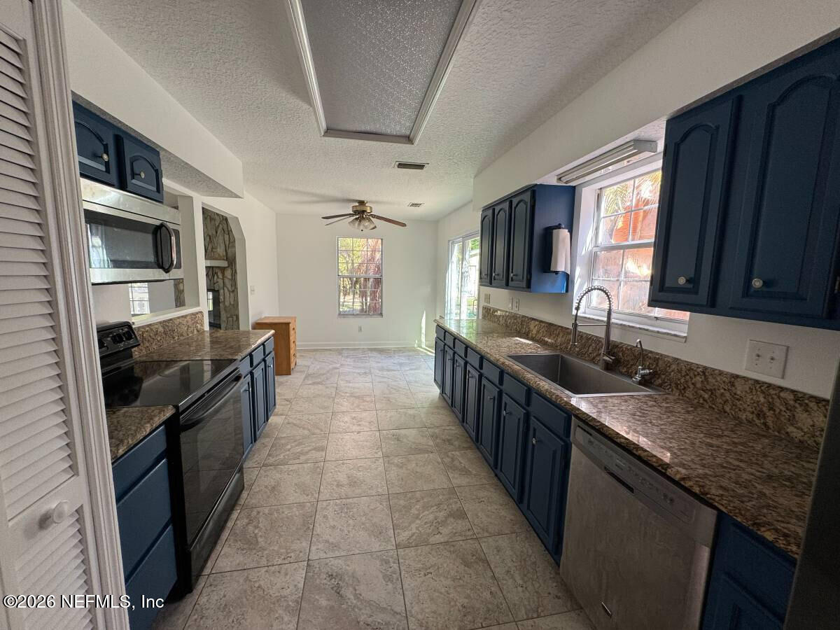 543 Ray Edwards Road St. Augustine, FL 32086 - Photo 5 of 19 a large kitchen with stainless steel appliances granite countertop a sink stove and refrigerator