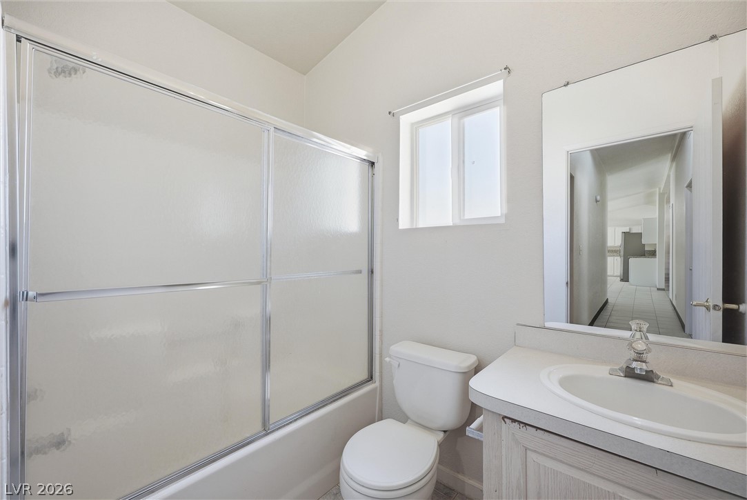 1531 West Harris Farm Road Pahrump, NV 89060 - Photo 33 of 37 Functional full bathroom featuring a tub-shower combination with sliding doors and a single vanity.