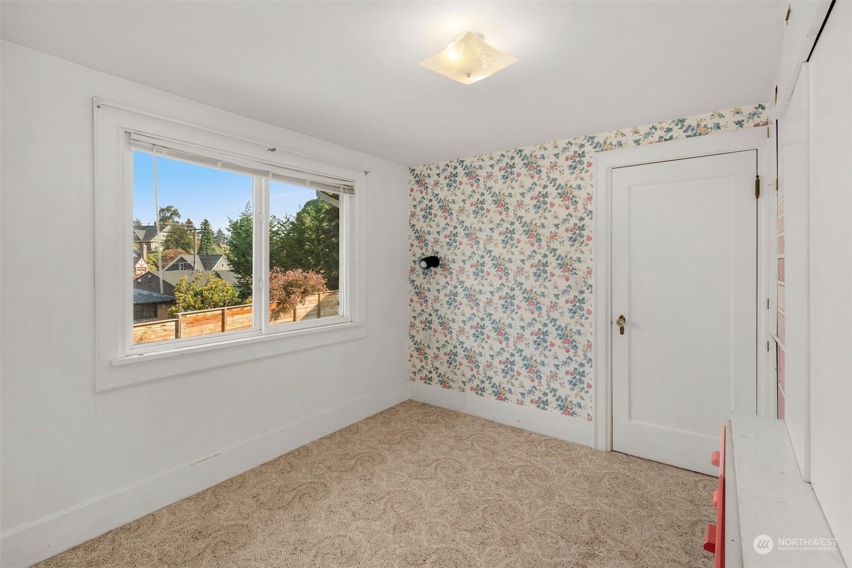 7518 Orin Court North Seattle, WA 98103 - Photo 18 of 40 en empty room with window and outdoor space