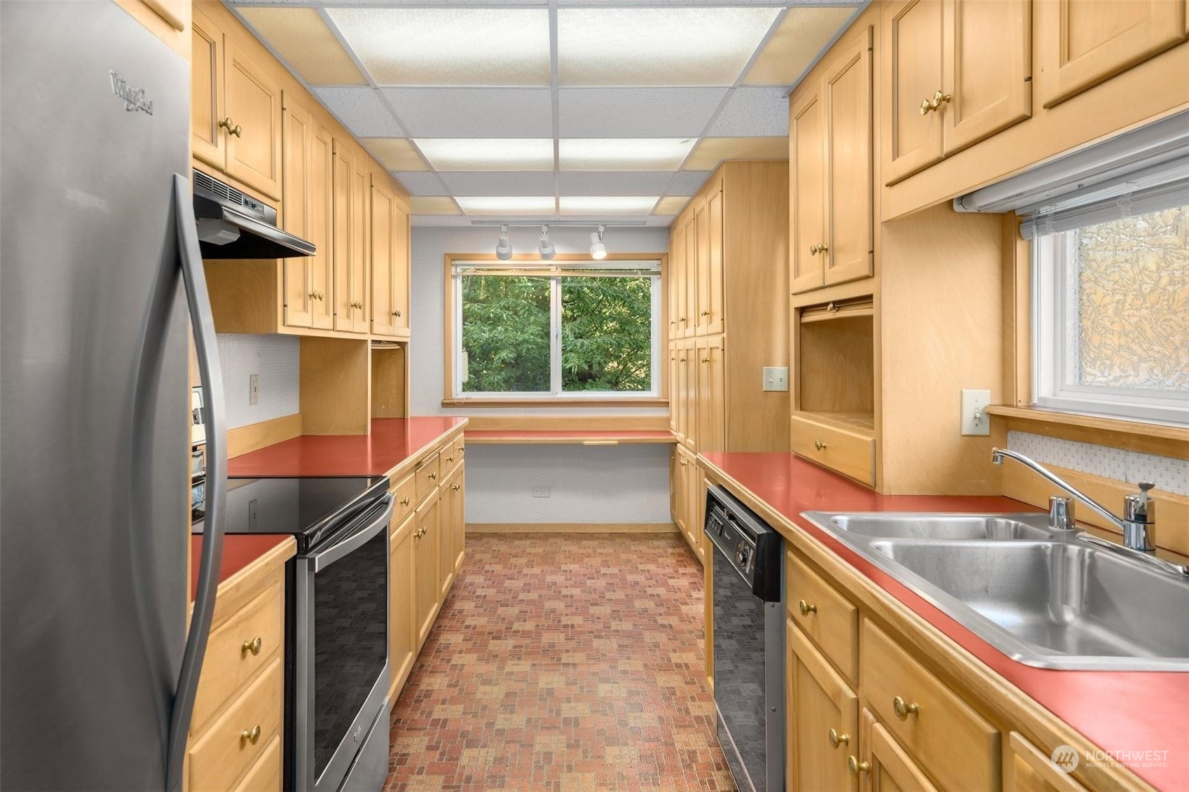 7518 Orin Court North Seattle, WA 98103 - Photo 29 of 40 a kitchen with granite countertop a sink and a stove
