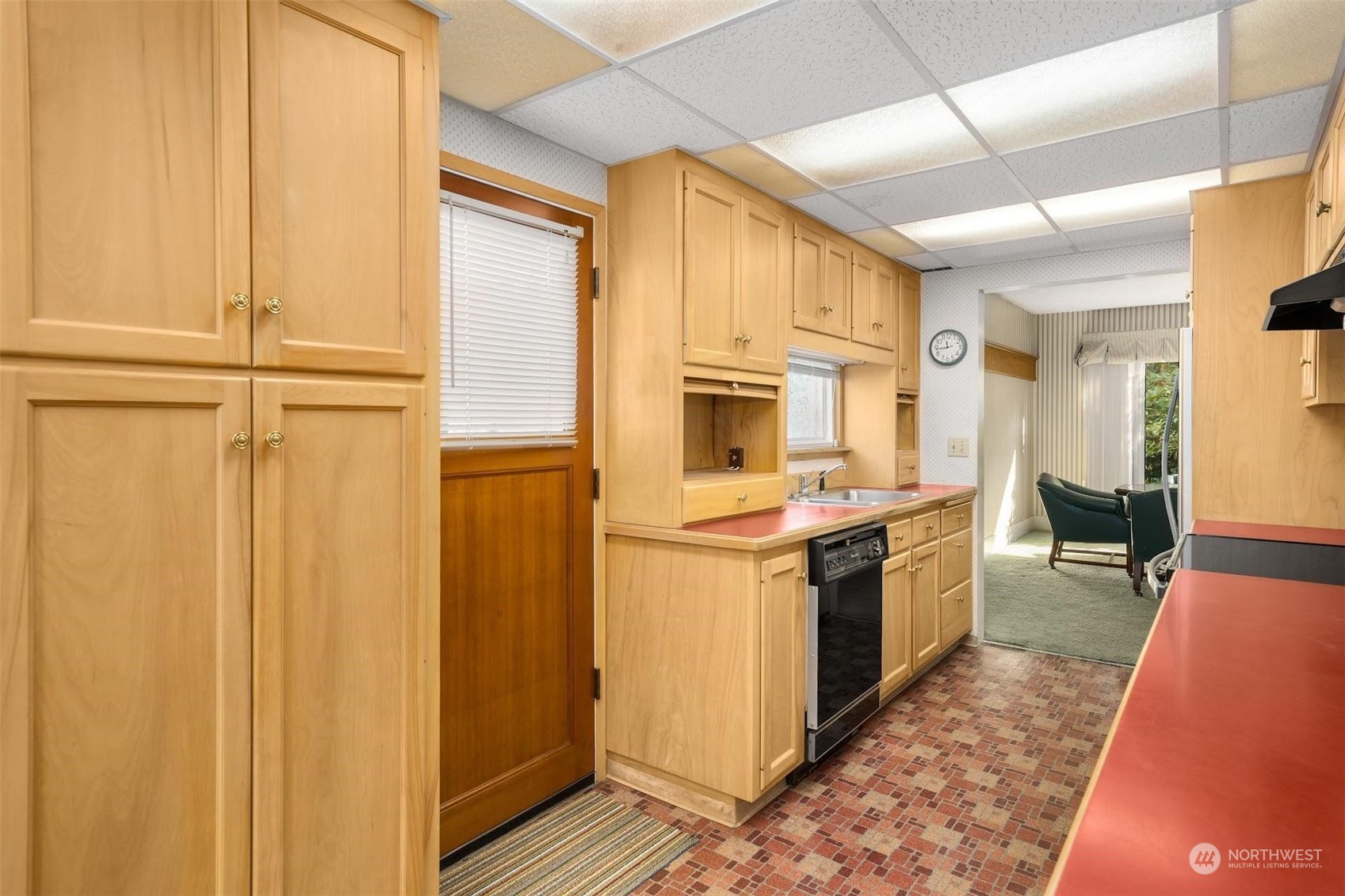 7518 Orin Court North Seattle, WA 98103 - Photo 30 of 40 a kitchen with stainless steel appliances granite countertop a refrigerator a stove and a sink with wooden floor