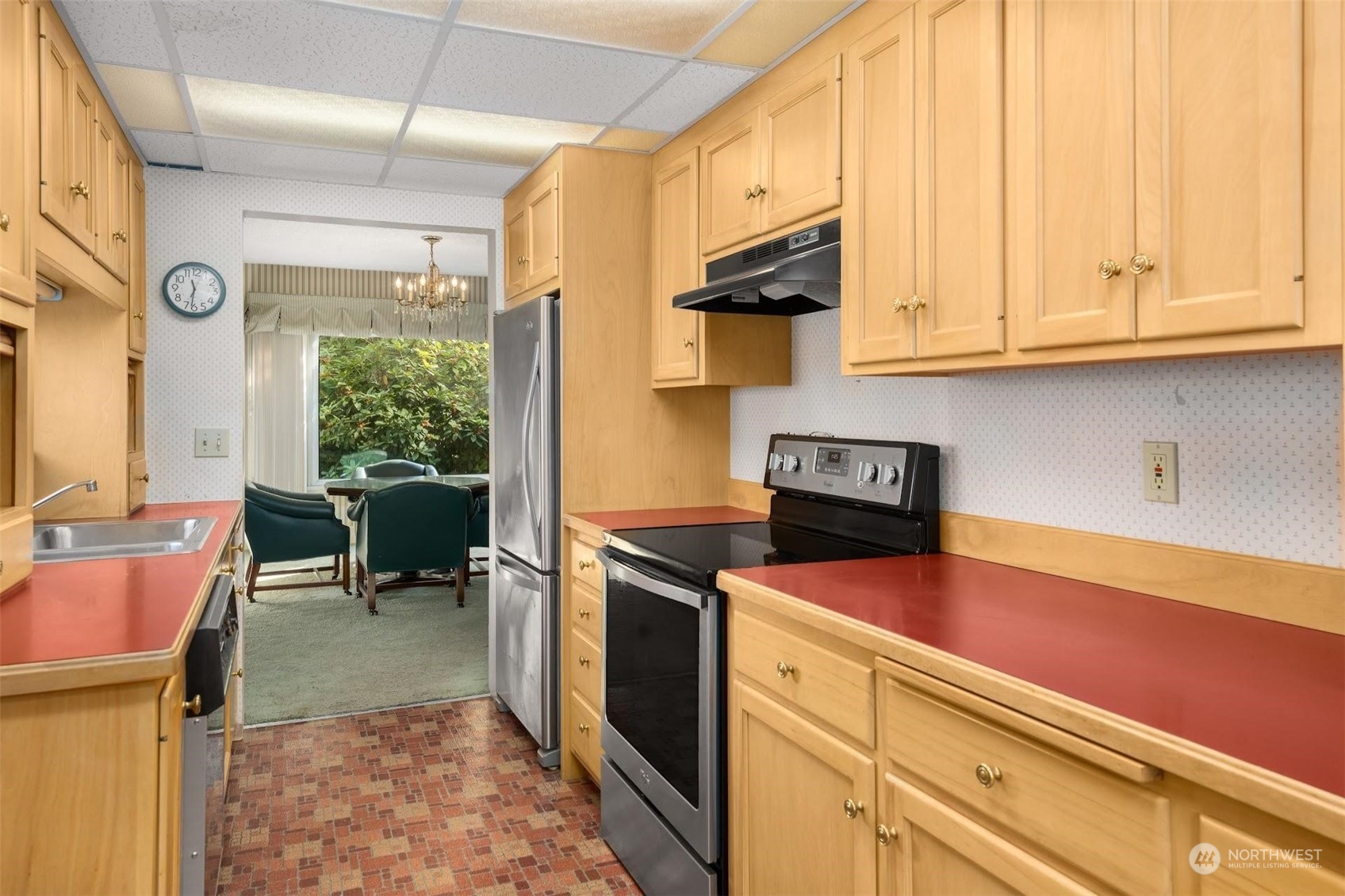 7518 Orin Court North Seattle, WA 98103 - Photo 31 of 40 a kitchen with stainless steel appliances granite countertop a sink and cabinets