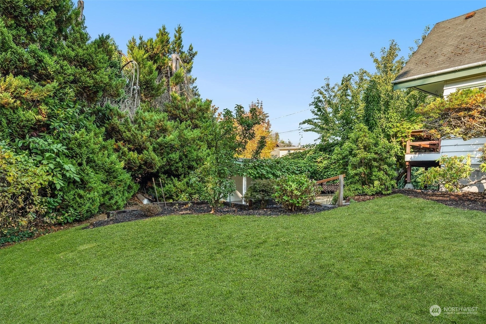 7518 Orin Court North Seattle, WA 98103 - Photo 9 of 40 a view of a yard with a house in the background