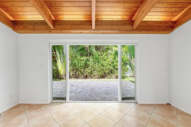 a living room with furniture a potted plant and a table