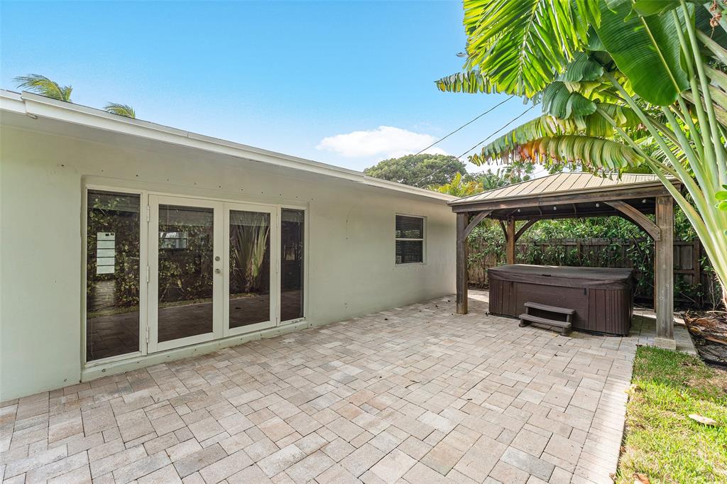 3203 Dover Road Pompano Beach, FL 33062 - Photo 28 of 54 a backyard of a house with barbeque oven and outdoor seating