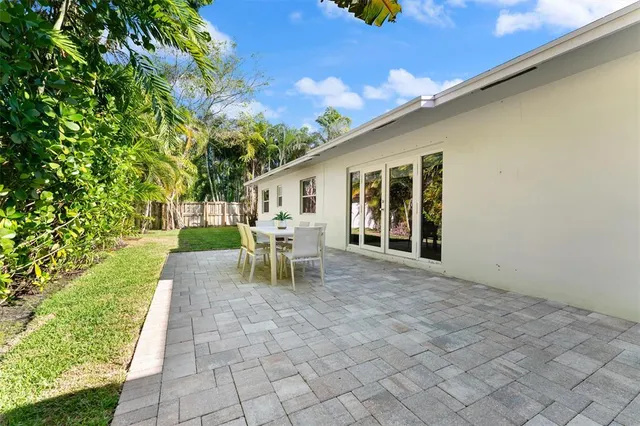 a view of a patio with table and chairs and potted plants