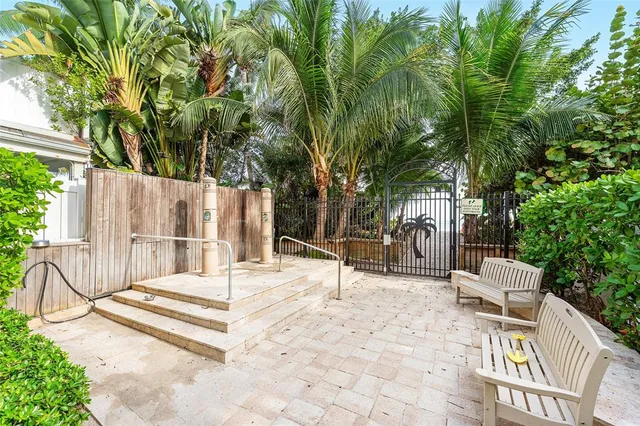 a view of house with backyard and sitting area