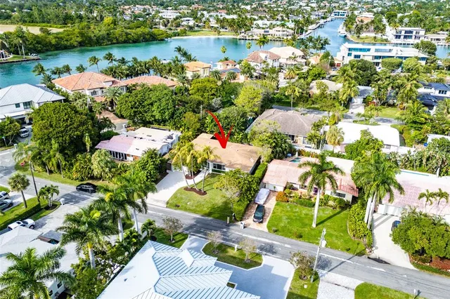 an aerial view of a house with a yard and lake view