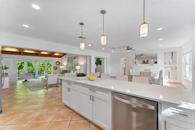 a kitchen with a sink counter top space and living room view