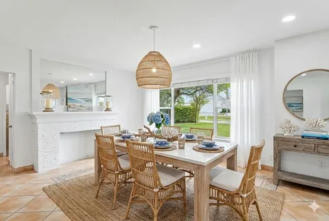 a kitchen with granite countertop white cabinets white appliances a sink and a window