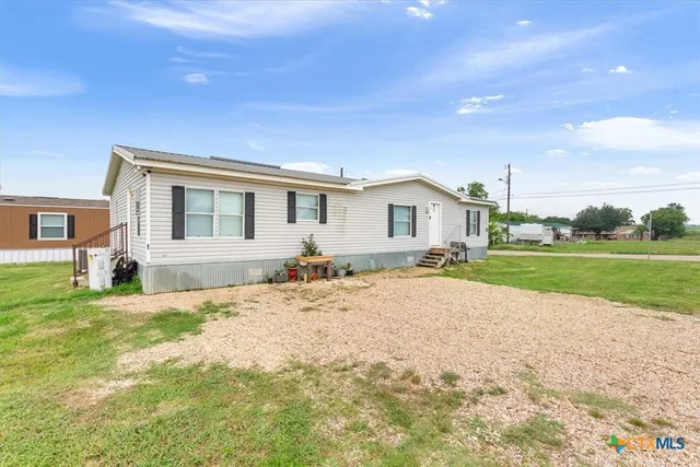 a view of a house with a backyard
