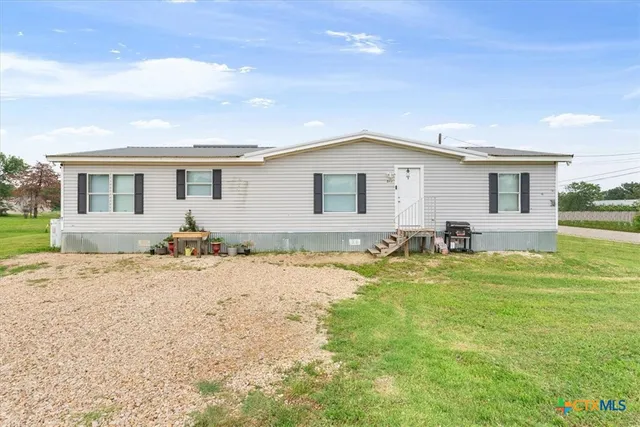 a large white house with a swimming pool