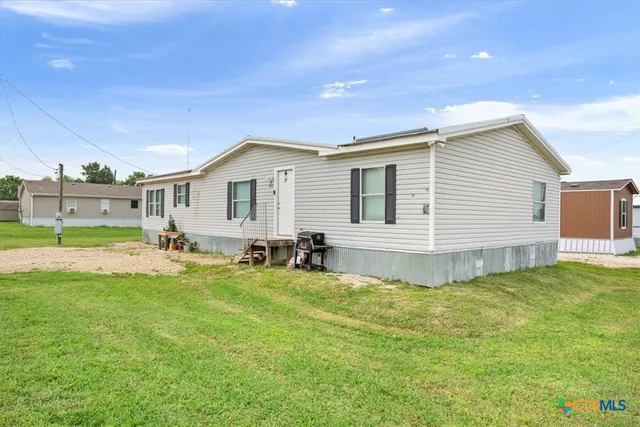 a view of a house with swimming pool and a yard