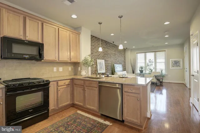 a kitchen with a sink stove and microwave