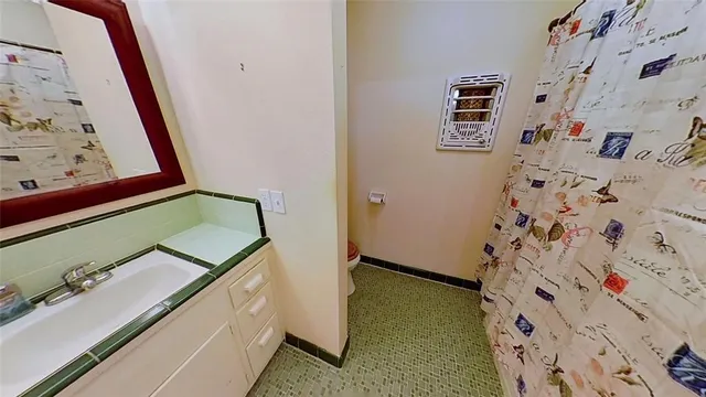 a bathroom with a shower and a mirror