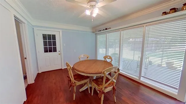 a dining room with furniture and wooden floor