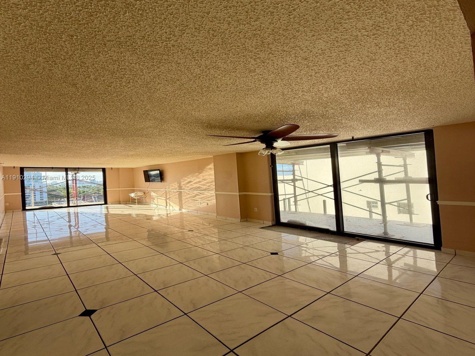 6061 Collins Avenue, Unit 11A Miami Beach, FL 33140 - Photo 18 of 30 a view of a livingroom with a large window