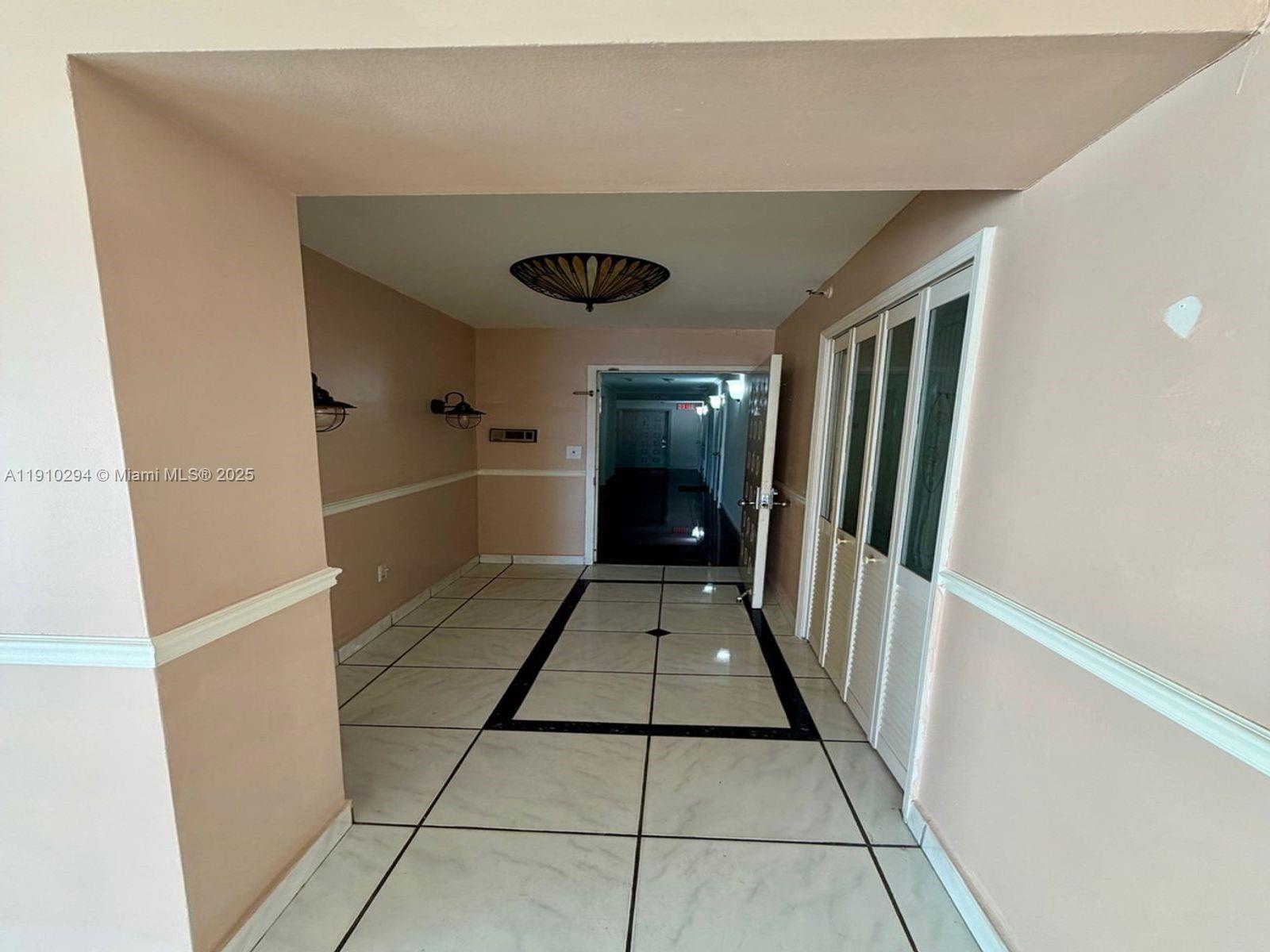 6061 Collins Avenue, Unit 11A Miami Beach, FL 33140 - Photo 21 of 30 a view of a hallway