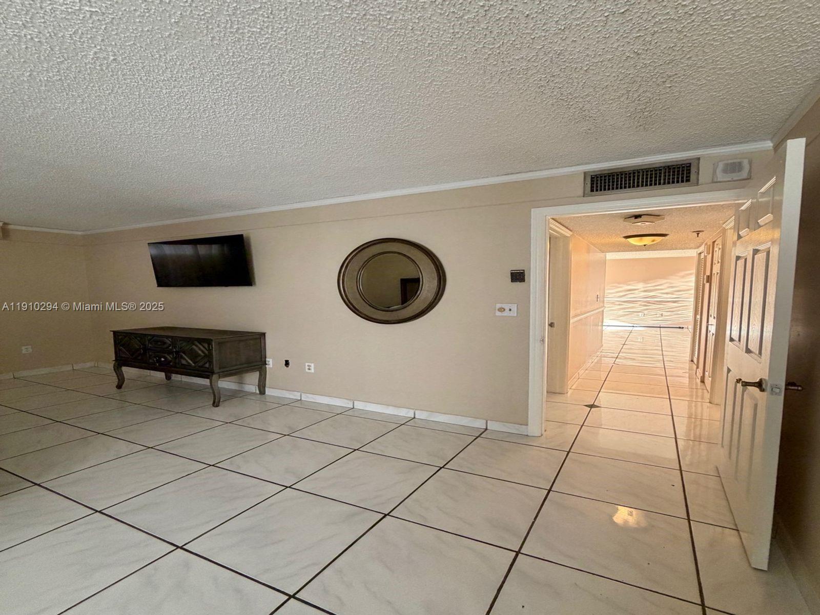 6061 Collins Avenue, Unit 11A Miami Beach, FL 33140 - Photo 26 of 30 a room with washing machine and a chair