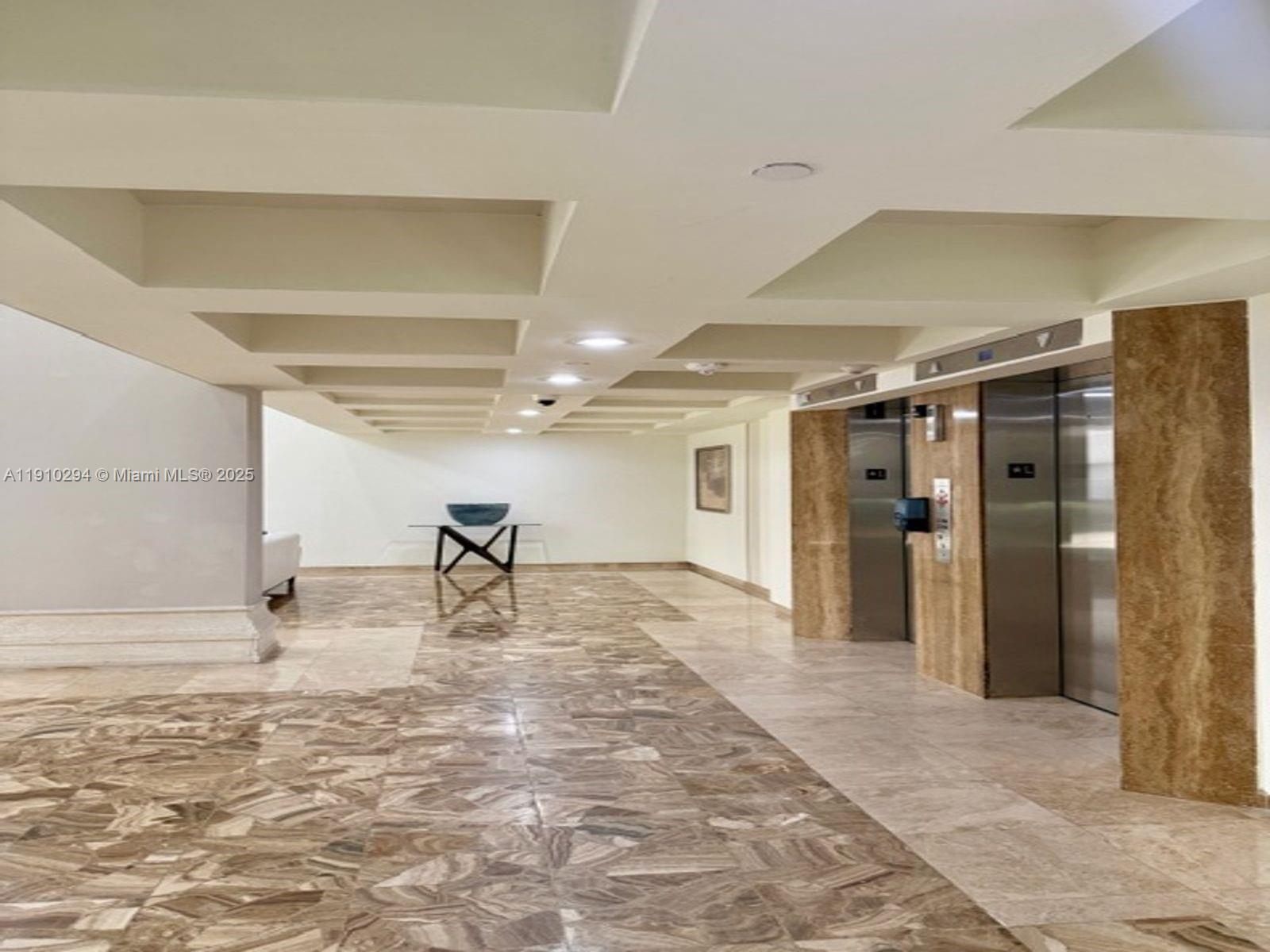 6061 Collins Avenue, Unit 11A Miami Beach, FL 33140 - Photo 6 of 30 a view of a hallway with wooden floor
