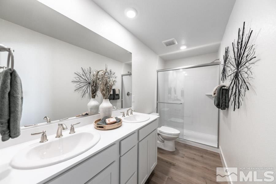 1605 Switchback Street, Unit LOT #29 Reno, NV 89523 - Photo 12 of 20 a bathroom with a double vanity sink toilet and shower